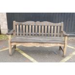 A teak garden bench by P.J. Bridgman & Co, 63½" long