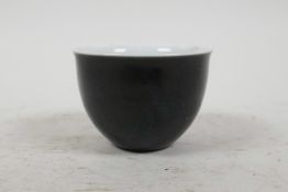 A small Chinese famille noire sake cup painted with all over black glaze and 4 character mark to