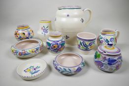 A good selection of Poole Pottery from the 1920s onwards, with hand painted floral and 'bluebird'