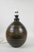 An Art Pottery lamp with swirled decoration, indistinctly signed and dated '79' to base, 14½" high