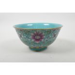 A Chinese polychrome porcelain rice bowl with enamelled scrolling lotus flower decoration, seal mark