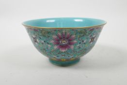 A Chinese polychrome porcelain rice bowl with enamelled scrolling lotus flower decoration, seal mark