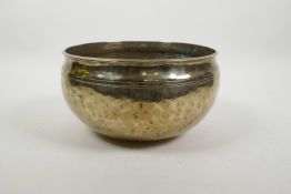 A Tibetan hammered brass singing bowl, 8½" diameter