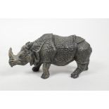 A cold painted bronze desk inkwell in the form of a rhinoceros, 4" long