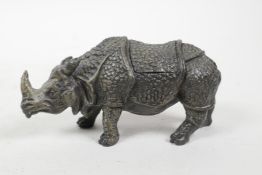 A cold painted bronze desk inkwell in the form of a rhinoceros, 4" long