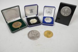 A collection of various medallions and coins including a silver plated 'Freedom Tower One