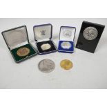 A collection of various medallions and coins including a silver plated 'Freedom Tower One