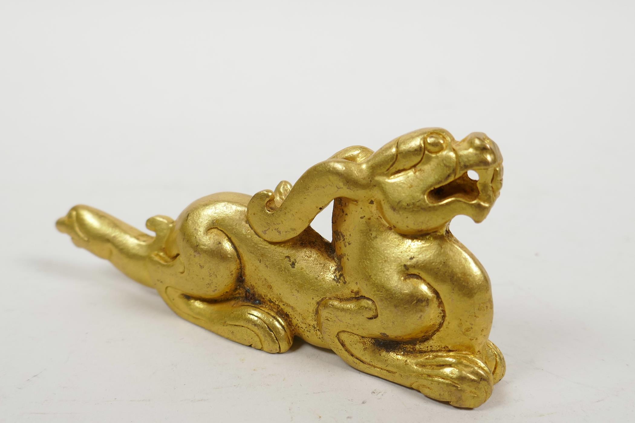 A Chinese gilt metal scroll weight in the form of a kylin, 5" long - Image 2 of 2