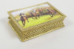 A gold plated pill box with a pictorial enamel plaque to the cover depicting the Grand National,