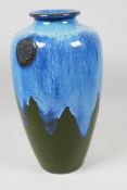 A studio pottery vase with blue and green drip glaze, 13" high