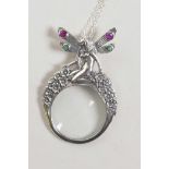 A silver magnifying glass pendant necklace with nude nymph decoration, 2" drop