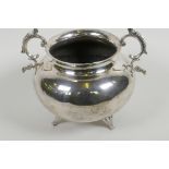 A hammered white metal bowl with two cast scroll handles and three cast supports, 7½" diameter, 585g