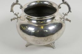 A hammered white metal bowl with two cast scroll handles and three cast supports, 7½" diameter, 585g