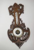 A Soviet banjo barometer/thermometer in a carved wood case, 18" long