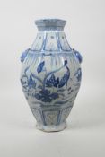 A Chinese blue and white Ming style pottery vase of octagonal form with two fo dog mask handles, and