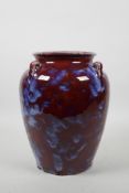 A Chinese pottery vase with four lug handles and a Jun ware style glaze, 4 character mark to base,