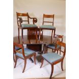 An early C20th mahogany twin pedestal dining table, with reeded edge, solid top and extra leaf,