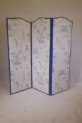 A Chinoiserie upholstered screen with four folding leaves in cream and blue fabric depicting