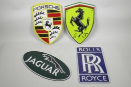 Four painted cast metal plaques of automotive interest, 7½" x 11½"