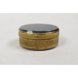 A gilt metal oval pill box with inset bloodstone cover and base, 1½" long