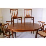 A G Plan teak dining table with fold out leaf, 44" x 66" x 84" extended, and a set of six chairs