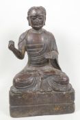 A bronze figure of a bearded Buddhist seated in meditation with splash gilt highlights, 10" high