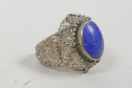 A medieval style white metal ring set with a reconstituted blue stone