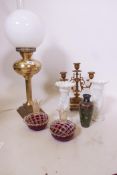 A pair of opaline glass vases, 8" high, a three branch brass candelabrum, a brass table lamp, and