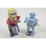 A Chinese tin plate walking toy robot, 5" high, together with a dressed plastic musical monkey