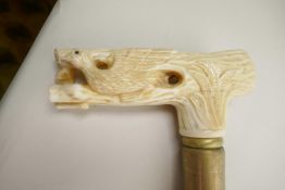 A hardwood walking cane with carved bone handle in the form of a bird in a tree, 34½" long
