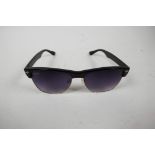 A pair of RayBan sunglasses with black frames and mauve tinted glass in a Lipsy of London hard case