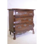 An oak Dutch style bombe fronted three drawer chest, with shaped top, raised on carved supports, 26"