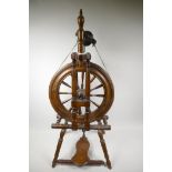 An antique fruitwood spinning wheel, 3½" high
