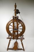 An antique fruitwood spinning wheel, 3½" high