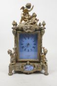 A French brass mantel clock with enamelled copper panels and dial, decorated with winged putti,