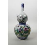 A Chinese polychrome porcelain double gourd vase with a slender neck decorated with birds and