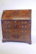 A Georgian mahogany fall front bureau, with shaped fitted interior over four long drawers, with swan