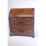 A Georgian mahogany fall front bureau, with shaped fitted interior over four long drawers, with swan