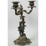A gilt metal three light table candelabra, the scrolling base with bronze figure of a musician