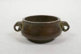 A Chinese bronzed metal censer with two elephant mask handles, 4 character mark to base, 3" diameter