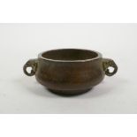 A Chinese bronzed metal censer with two elephant mask handles, 4 character mark to base, 3" diameter