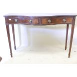 A C19th serpentine front mahogany serving table, with reeded edge top and two drawers with ring