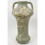 A decorative Satsuma porcelain vase with two handles, decorated with stylised flowers on a pale