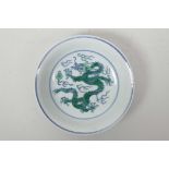 A Chinese blue and white porcelain dish with green enamelled dragon and flaming pearl decoration,