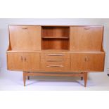 A 1970s G-Plan teak 'fresco' side cabinet designed by Victor Wilkins, 74" x 18", 48" high