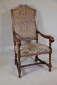 A Continental walnut high back open armchair, with scrolled end arms and shaped back, raised on
