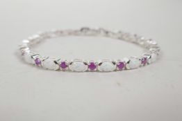 A silver link bracelet set with rubies and opalites, 7½" long