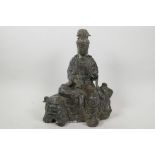 A Chinese bronze figurine of Quan Yin seated on a kylin with verdigris patination, 11" high