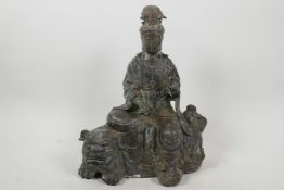 A Chinese bronze figurine of Quan Yin seated on a kylin with verdigris patination, 11" high