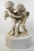 A plaster figure of two squabbling cherubs on an octagonal base, A/F, 18" high